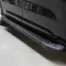 Black pickup truck viewed from the side, showing a textured metal running board (side step) beneath the doors